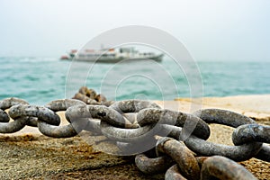Rusty Ship Anchor Chain On Dry Coast In The Port.