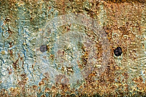 Rusty ship hull with two holes