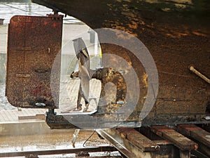 Rusty ship propeller with rudder blade