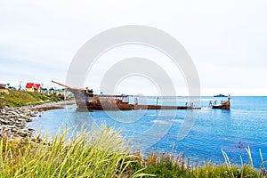 Rusty ship ran aground, Puerto Natales, Chile. Copy space for text