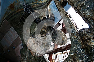 Rusty ship screw covered in shells during repair work