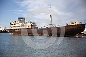 Rusty ship on the sea shore