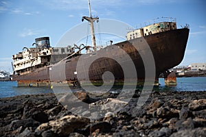 Rusty ship on the sea shore