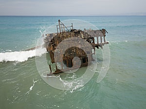 Rusty ship wreck surrounded by green sea, Cyprus