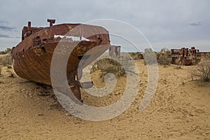 Rusty ships at the ship graveyard in former Aral sea port town Moynaq Mo ynoq or Muynak , Uzbekist