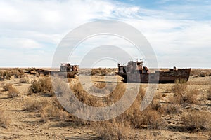 Rusty ships at the ship graveyard in former Aral sea port town Moynaq Mo ynoq or Muynak , Uzbekistan