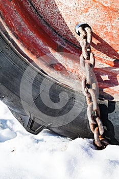 rusty snow chain fitted to tractor wheel