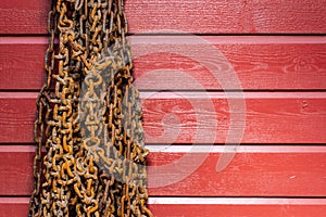 Rusty snow chains hanging on a rew wooden wall photo
