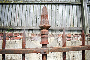 A Rusty Spike on an Old Metal Fence