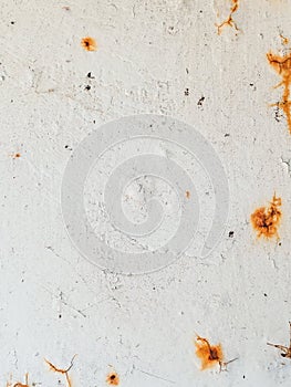 Rusty stains and cracks on a white metal surface