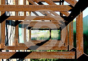 Rusty steel recurrent rectangular constructions welded together photo