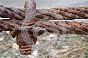 Rusty Steel Ropes with Shiny U-Bolt Clamp on Blue Sky Background. Business Teamwork Support Together Concept.