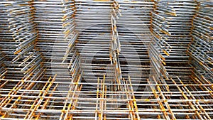 Rusty steel welded wire mesh background. Reinforcing frame of the base plate. Building materials warehouse for construction of fou