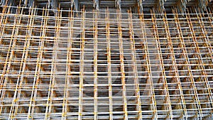 Rusty steel welded wire mesh background. Reinforcing frame of the base plate. Building materials warehouse for construction of fou