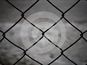 Rusty steel wire mesh fence.