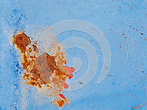 Rusty surface of metal plate with blue cracked color paint.