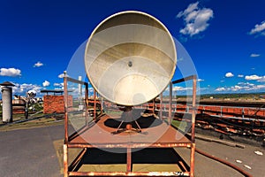Rusty telecommunication tower with old satellite system consist of old satellite dish antenna is located on the roof an