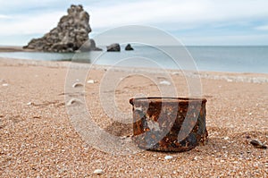 Rusty tin can on the beach