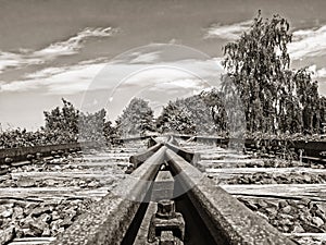 Rusty tracks of a disused railroad line leading to nowhere, sepia toned image