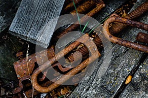 Rusty Turnbuckles discarded with some weathered lumber
