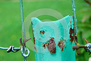 Rusty and twisted wire on a fence in a countryside field