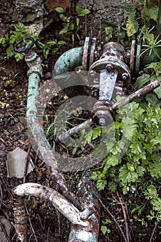 A rusty valve and pipes of old water tower