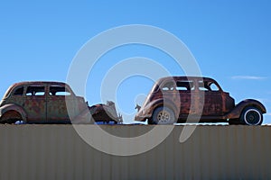 Rusty vintage automobiles on display