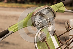 Rusty vintage mod green scooter bike handlebar, mirrors and headlamp