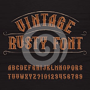 Rusty vintage typeface. Retro alphabet font. Metalic letters and numbers on a dark rough wooden background.