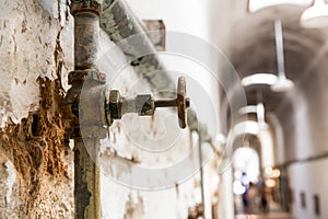 Rusty water pipes of old prison.