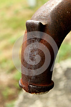 Rusty Waterpipe in a green background