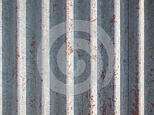 A rusty and weathered looking piece of corrugated metal. Old steel background. Metal sheet texture. Old galvanized iron backdrop.