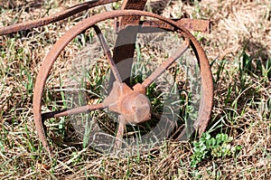 A rusty wheel of an old plough