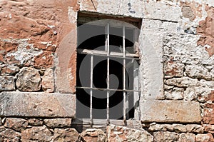 Rusty window grille and old block brick wall