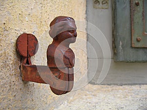 Rusty window shutter keeper on a wall