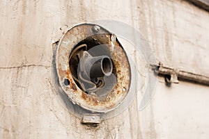 A rusty, worn out cartridge for a street lamp. The problem of urban lighting