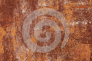 Rusty yellow-red textured metal surface. The texture of the metal sheet is prone to oxidation and corrosion. Grunge