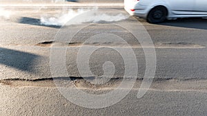Rut on asphalt road in the city. Road requiring repair, example of corruption in the repair of roads in Russia