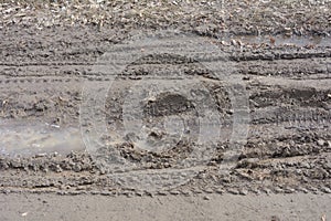 Rut in mud from wheels of car. Dangerous dirt road in early spring. Close-up, selective focus