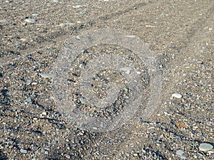 Rut in the sand. Tracks from car wheels on the beach. Sand and stones