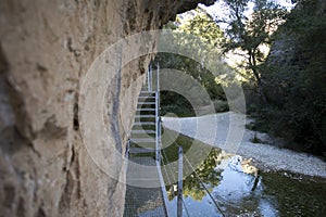 Ruta de las pasarelas, AlquÃ©zar. Beautiful route across the river crossing metal walkways and nature trails through the mountain. photo