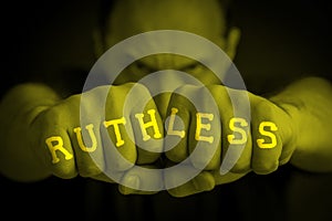 RUTHLESS written on an angry man fists