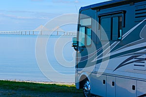 RV at beach with Tampa Bay Sunshine Skyway Bridge photo