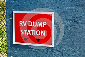 An RV dump station sign on the edge of a building