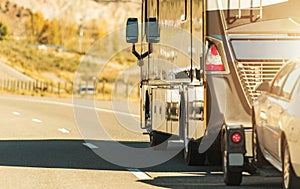 RV Motor Coach with Pull Vehicle on a Highway