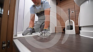 RV Rentals Worker Cleaning Shower Cabin Inside a Camper Van Motorhome