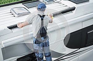 RV Service Worker Cleaning Camper Van Roof