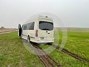 A RV Sprinter Van stuck in the mud in the Wall, SD boondocking spot in Badlands National Park