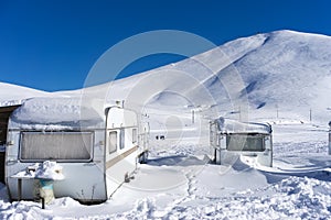 RVs covert in snow at Falakro, in Greece.