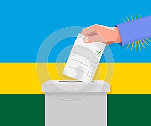 Rwanda election concept. Hand puts vote bulletin